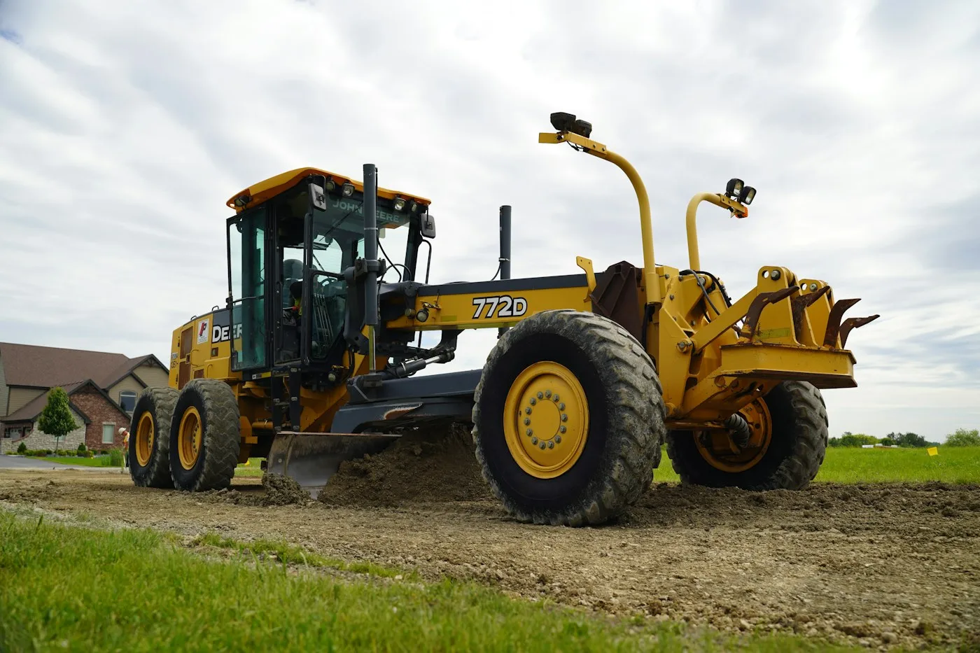 Motor grader parked beside open ground