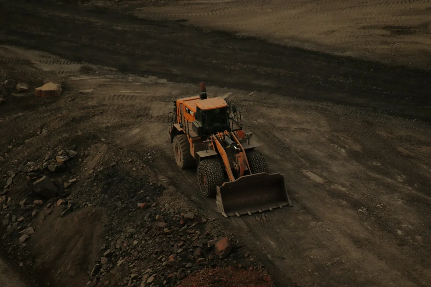 Aerial view of a loader on exposed earth